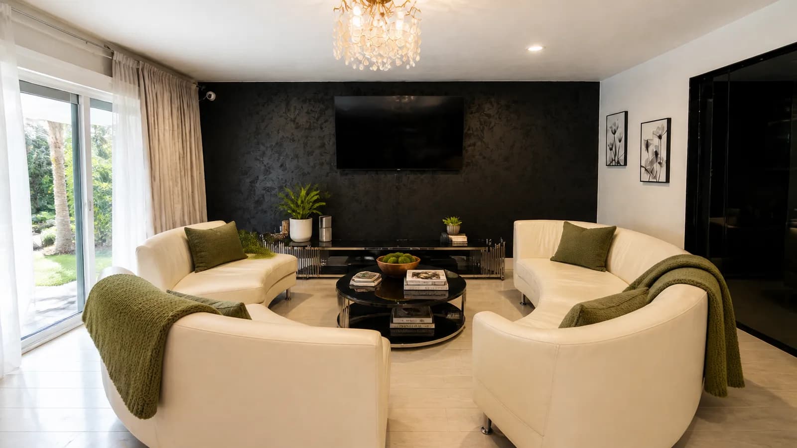 The common living room at Providence Detox, curved cream sofas facing a dark media wall.