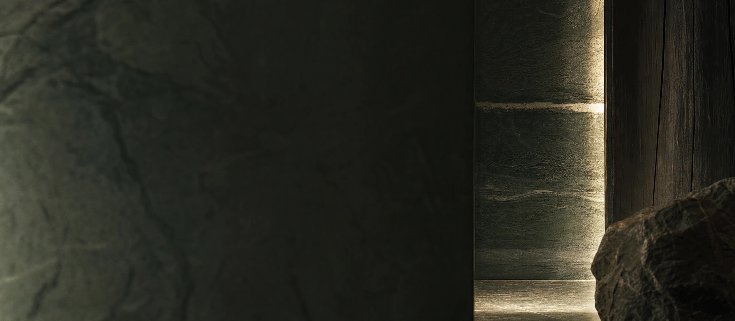 Abstract dark stone architecture with a narrow band of natural light.