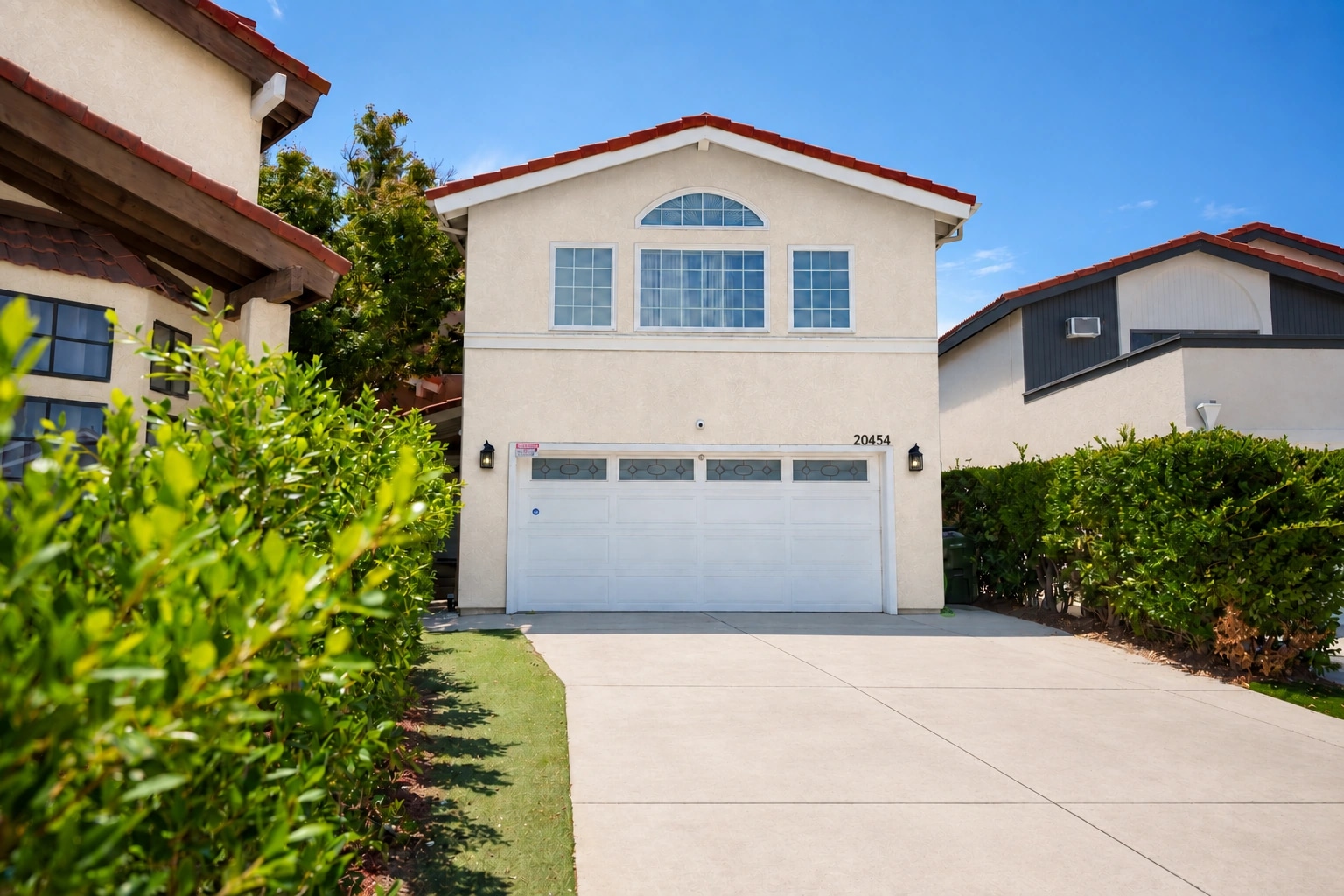 Residence garage and front entrance in daylight.